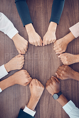 Buy stock photo Top view, business people and fist in support circle, team building or collaboration motivation for success goals or target mission. Men, women or worker hands in huddle on table for diversity growth