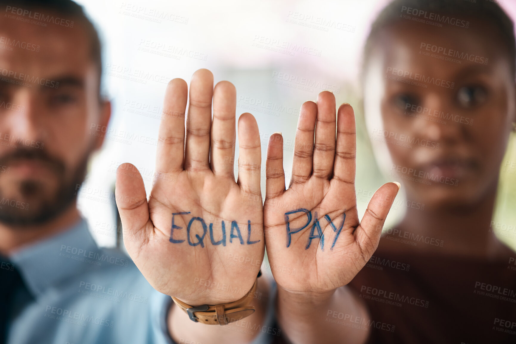 Buy stock photo Hands, equality and empowerment with a business man and woman showing an equal pay notice in their palms. Team, community and collaboration with male and female colleagues standing together in unity