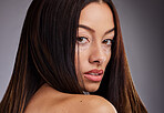 Beauty, vitiligo and portrait of a woman with a skincare treatment for wellness, health and cosmetics. Natural face, piebald skin and model from Mexico isolated in a studio with a gray background.