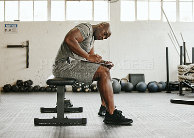 Buy stock photo Gym membership, personal trainer and black man writing on clipboard for exercise, training or workout schedule and program. Male sports coach working on health, wellness and fitness plan or goals