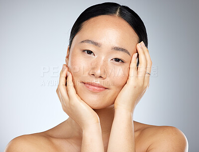 Buy stock photo Skincare, beauty and woman with facial wellness against a grey mockup studio background. Face portrait of a young, Asian and happy model with luxury cosmetics from dermatology and mock up space