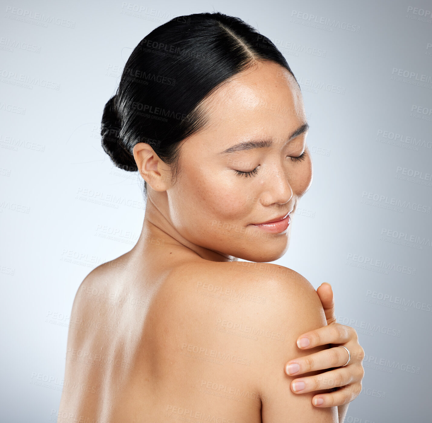 Buy stock photo Beauty, skincare and body cream with woman touching her shoulder and skin after routine dermatology therapy. Smile, happy and natural asian girl and model posing for wellness, health and cosmetics