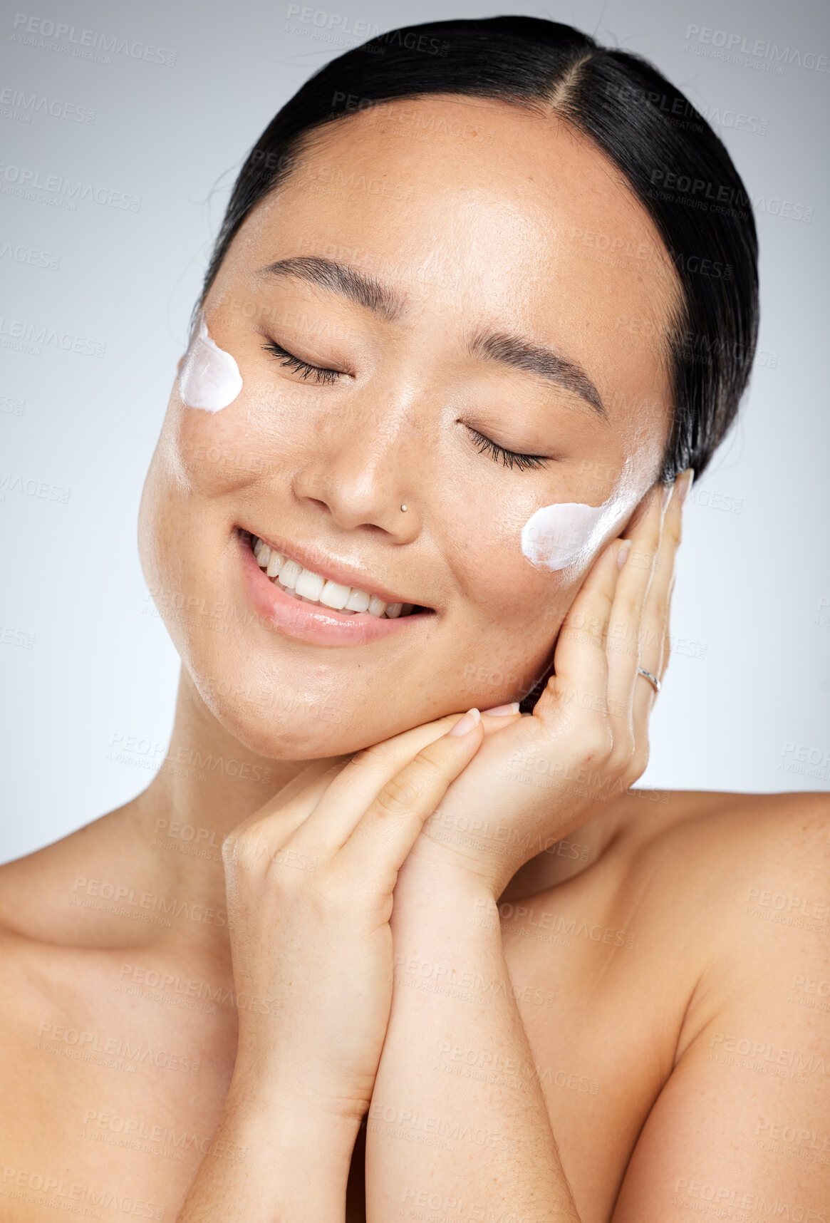 Buy stock photo Facial cream, skincare and happy woman with sunscreen product, face moisturizer or beauty cosmetics in studio. Headshot portrait of a healthy Asian model with a big smile after self care wellness