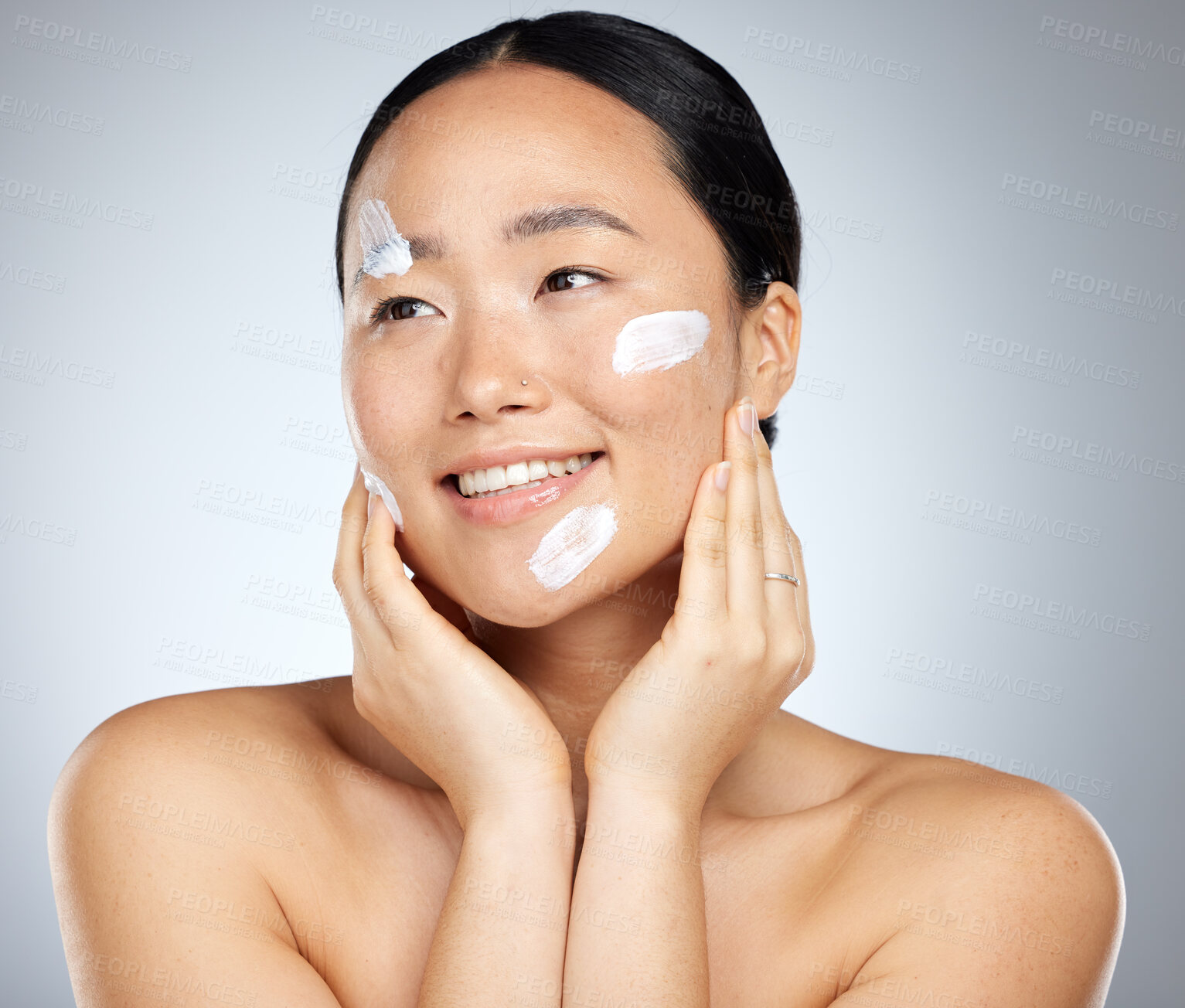 Buy stock photo Woman with sunscreen on face in studio, skincare cream product for natural uv protection and cosmetic wellness. Spa advertising beauty facial, happy korean girl with smile and dermatology spf lotion
