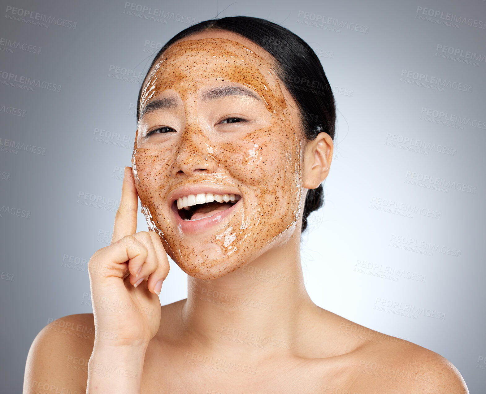 Buy stock photo Skincare, portrait and woman with a coffee face mask for fresh, clean and beautiful skin in studio. Beauty, dermatology and happy girl model from Japan with facial scrub isolated by a gray background