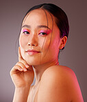 Happy woman, cosmetic makeup and natural facial skincare wellness. Portrait of young asian girl face, smile and feminine bright neon pink eye shadow beauty glow against brown studio background
