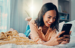 Happiness, social media and woman on bed with phone, smiling, laughing and relaxing at home. Meme, online and girl on smartphone texting, chatting and browsing internet in bedroom to relax on weekend