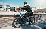 Bike, portrait and man cycling in a park for travel, adventure and sport in the city of Canada. African person training with a bicycle in the street for eco friendly and sustainable transportation