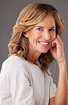 Face, portrait and beauty with a senior woman in studio on a gray background to promote antiaging. Skincare, product and retirement with a mature female pensioner posing for wellness or health