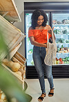 Happy customer shopping for food at a grocery supermarket for healthy nutrition, vegetables and fruits. Smile, lifestyle and young woman buying fresh organic groceries on sale at a convenience store