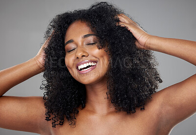 Buy stock photo Hair care, black woman and with smile, confident and happy with curly hair, wavy and with grey studio background. African American female, girl and with body care for natural beauty, health and glow.