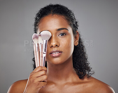 Buy stock photo Beauty, black woman and portrait with brush cover on face for cosmetic powder or foundation tools. Makeup, cosmetics and brushes for beautiful girl model with grey studio mockup for marketing.

