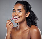 Lipstick, woman and lip cosmetics, makeup and smile in a mockup grey studio background. Beauty girl model happy with health, wellness and skincare with healthy, glowing and smooth skin results