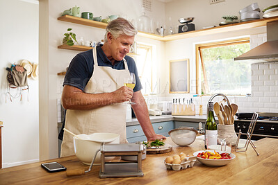 Buy stock photo Wine, cooking and senior man in the kitchen preparing a meal for dinner or lunch at his home. Happy, retirement and elderly guy drinking an alcohol beverage with food to cook for a date at his house.