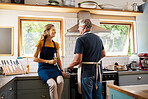 Retirement, senior couple and in kitchen have discussion, talking and being loving together while cooking. Love, mature man and elderly woman is romantic, happy and smile to enjoy anniversary at home