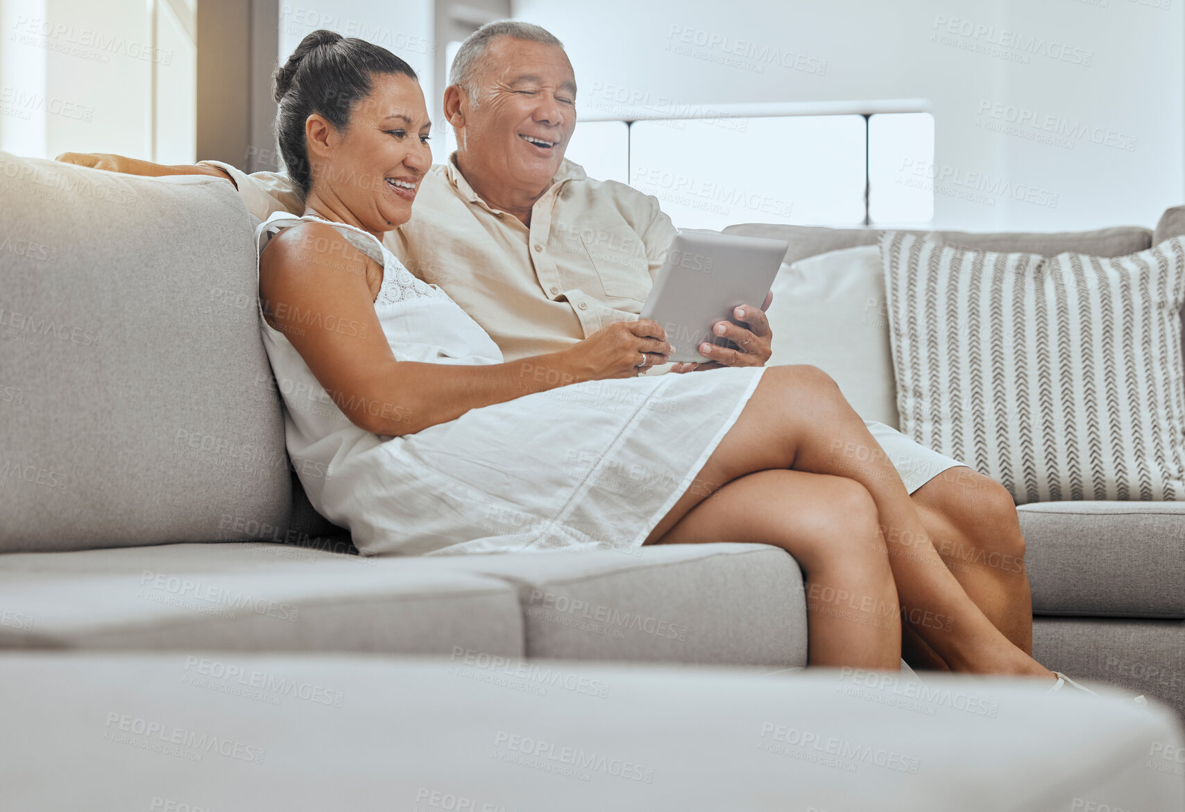 Buy stock photo Mature couple, digital tablet or relax bond on sofa in house or home living room on video call, social media or internet research. Smile, love or happy man or woman on live streaming movie technology