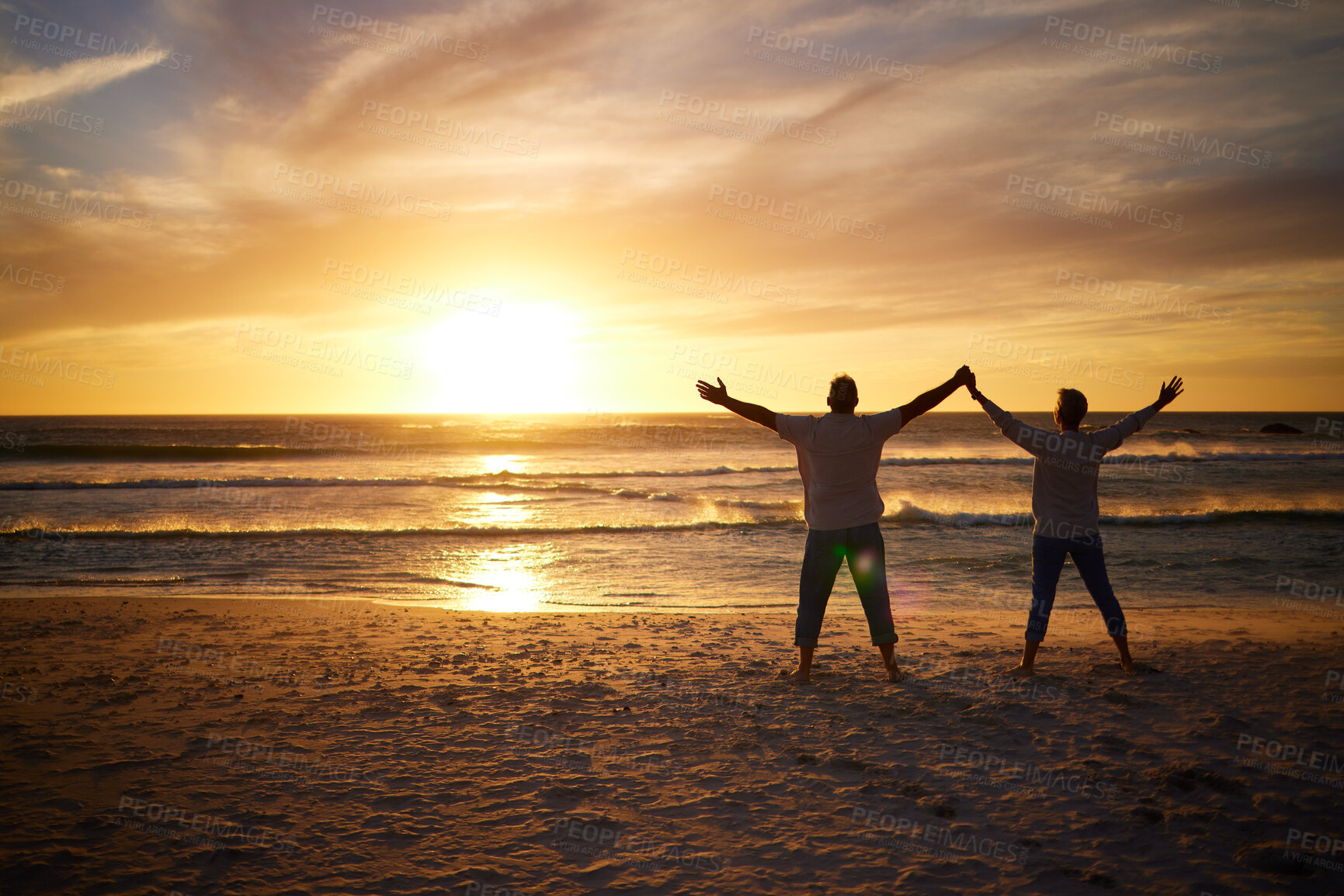 Buy stock photo Love, sunset and couple on beach for freedom, peace and calm for happiness, relax and carefree outdoor together. Romance, man and woman stand on holiday, vacation and travel holding hands to worship 