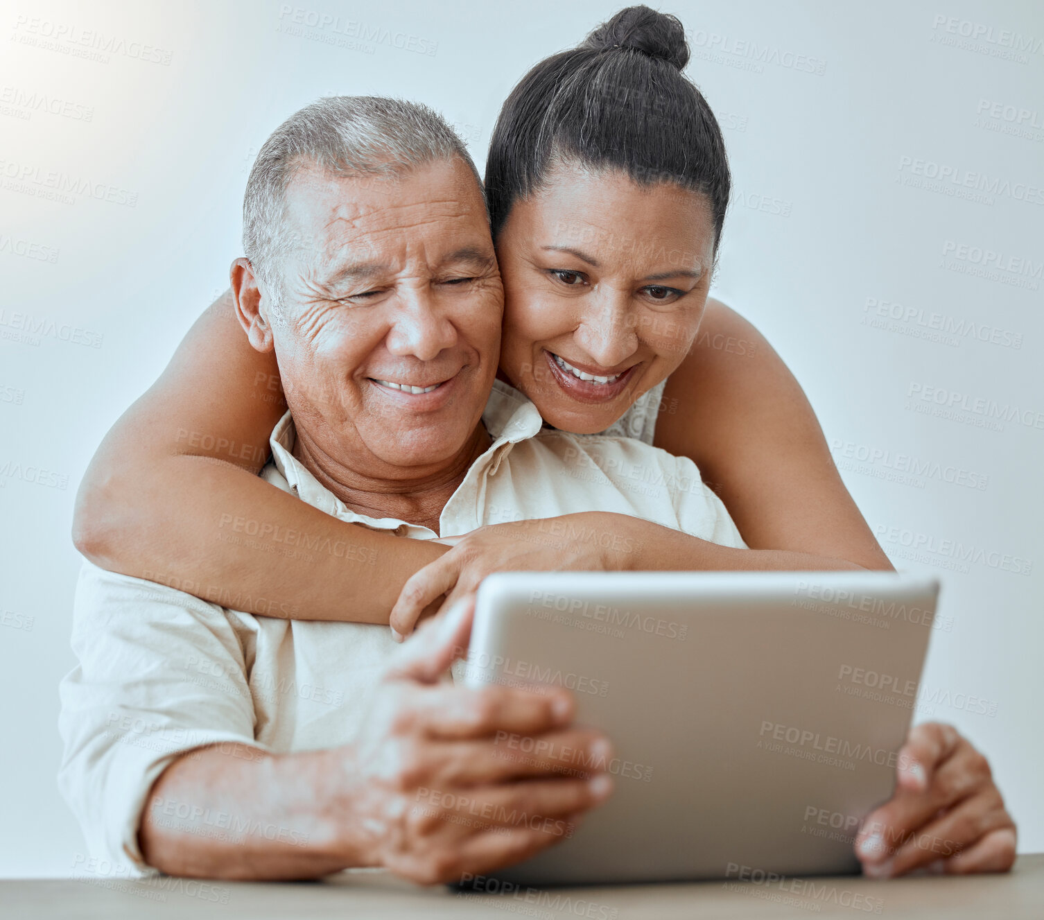 Buy stock photo Tablet, internet and love with a senior couple browsing online using wireless technology in the home together. Relationship, smile and happy with an elderly male and female pensioner surfing the web