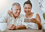 Happy, phone and couple watching a video on social media or the internet while relaxing at home. Happiness, smile and elderly man and woman streaming a movie on website with smartphone or technology.