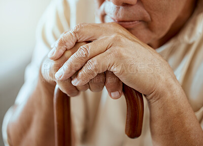 Buy stock photo Hands of elderly man on walking stick, serious and sitting thinking, memories at retirement home. Grandpa with wooden cane, senior care for disability and nostalgia for sad lonely guy at nursing home