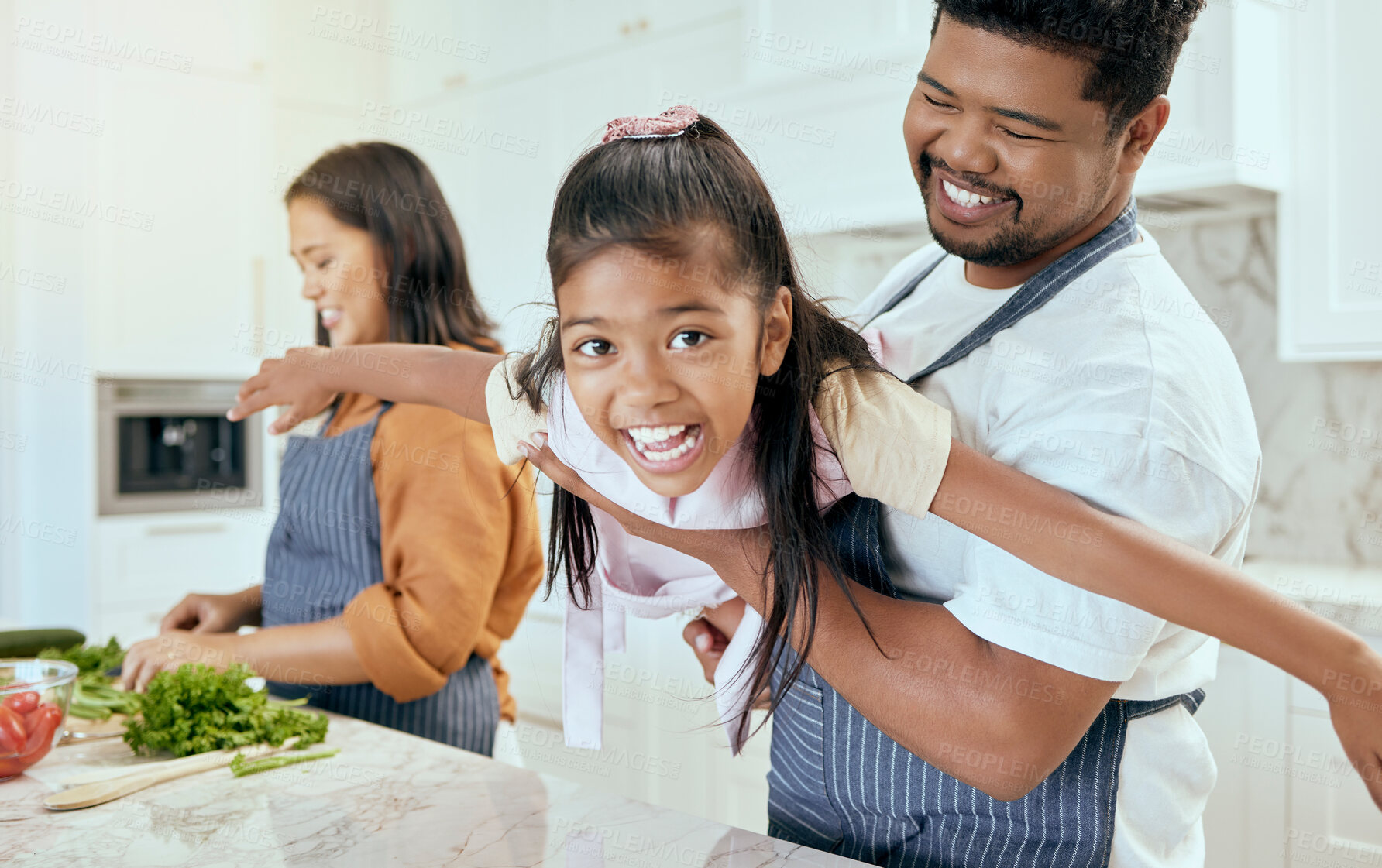 Buy stock photo Mother, father and child play while cooking in the kitchen bonding, laughing and having fun happy family home, Smile, mama and dad enjoy playing with girl or kid in a healthy dinner meal preparation 