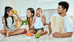 Asian, vegetables and family in kitchen for playing at table, happy or together for bonding. Mom, dad and children with smile at counter for health, food or nutrition with bags after shopping in home
