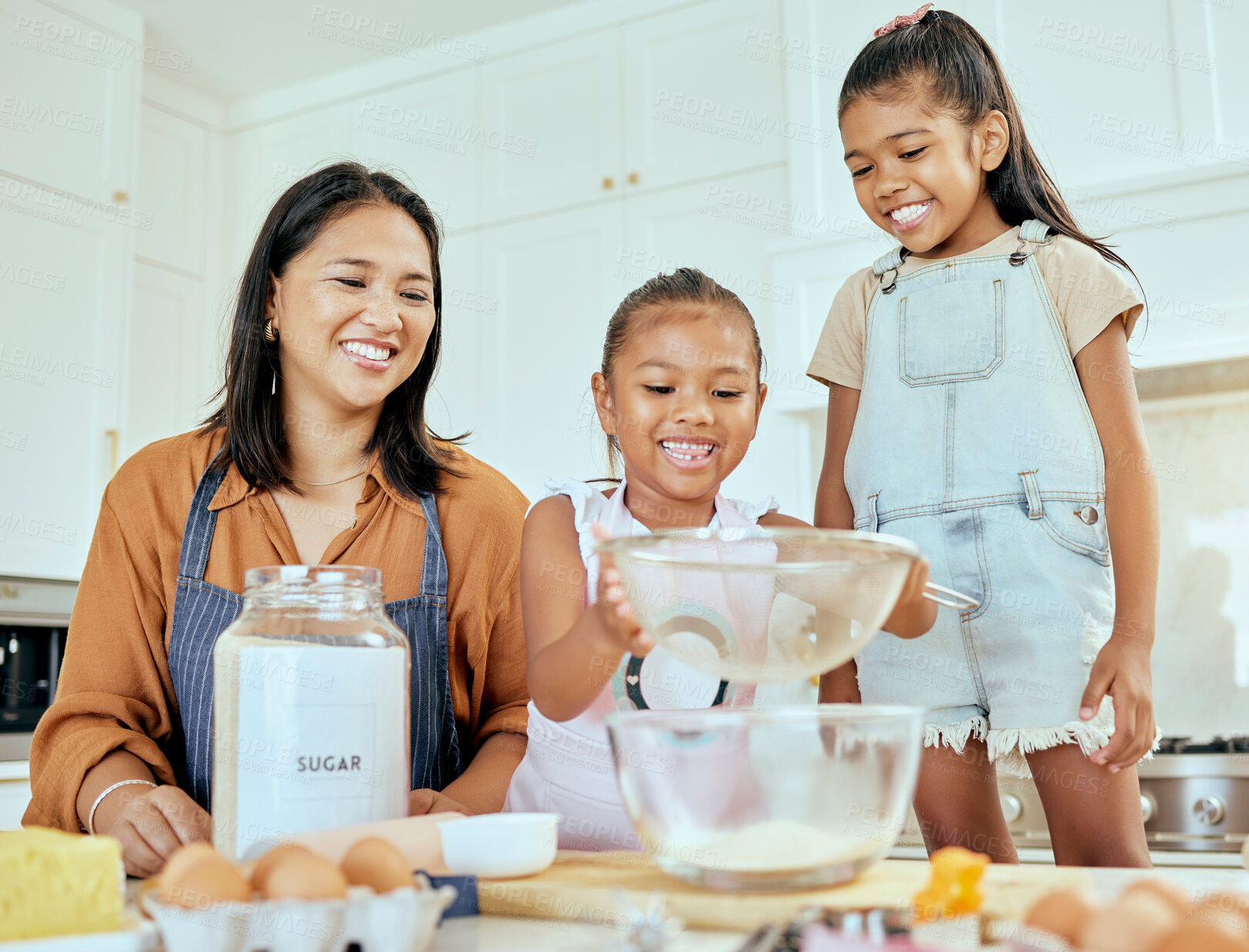 Buy stock photo Cooking, learning and mother with children in kitchen for food, breakfast and happy in the morning. Smile, wellness and help with kids chef and mom in family home for baking, health and cake together