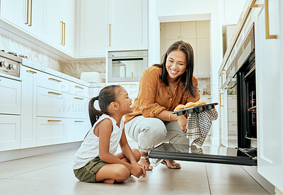 Buy stock photo Asian, mom and girl in kitchen at oven, baking and cupcakes with stove, happy and home. Mother, child and muffins for learning, education and cooking in house for skills, love or bonding in Jakarta