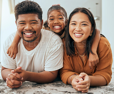 Portrait, girl and parents on the floor of their living room with hug, smile and care together. Face of a happy and excited mother, father and child in peace, calm and to relax in their lounge