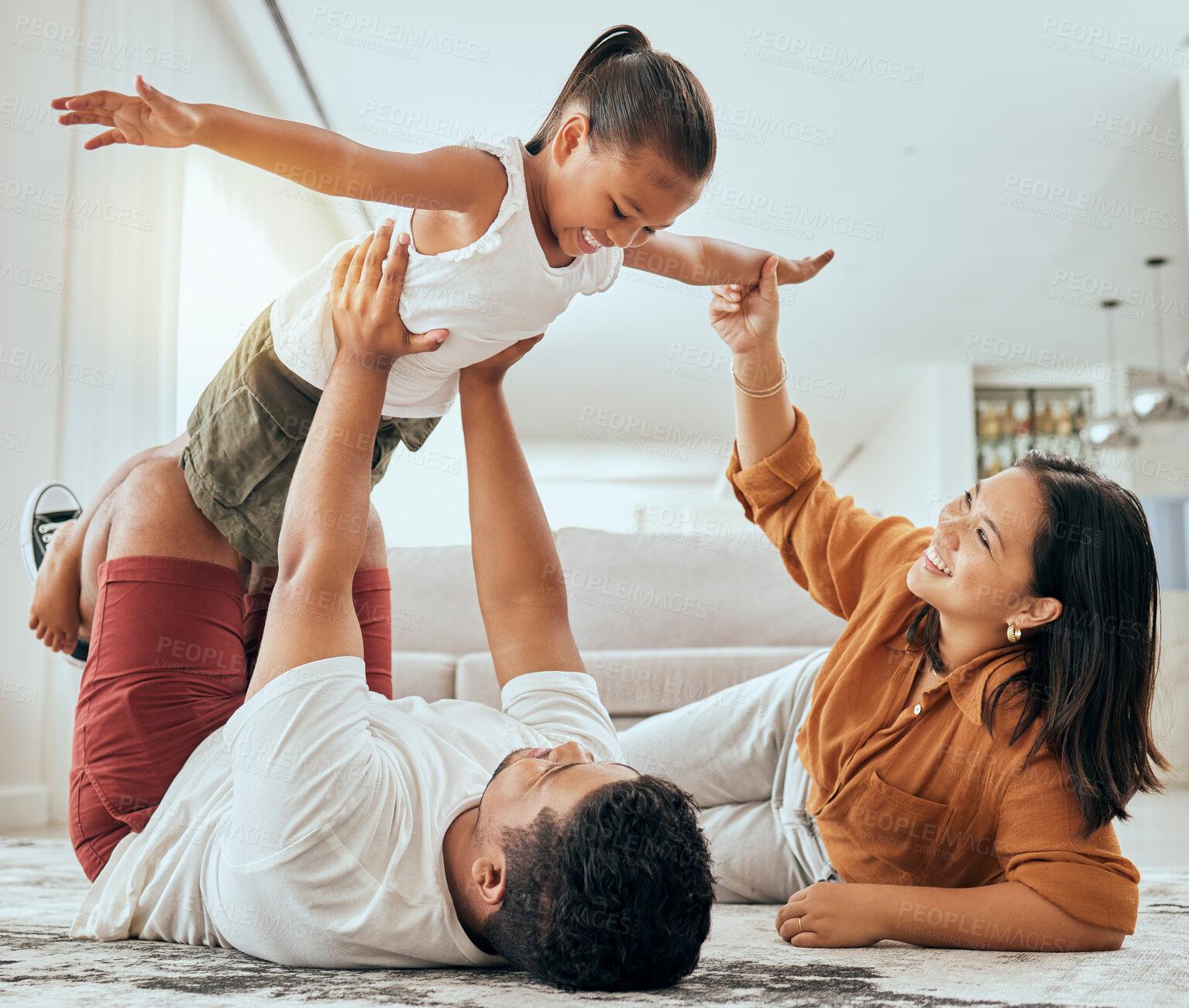 Buy stock photo Love, floor and fun happy family play, bond and enjoy quality time together while excited and relax on ground carpet. Happiness, care and childhood relationship of mom, dad and kid girl playing games