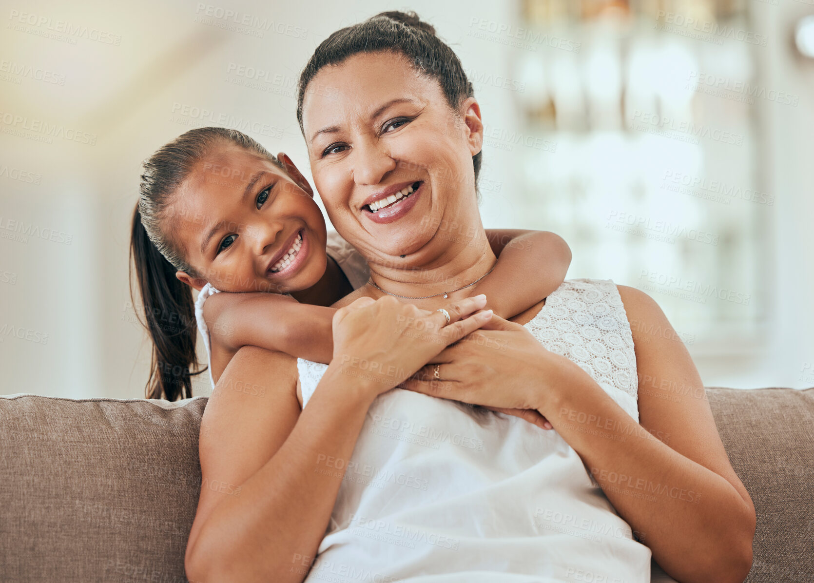 Buy stock photo Love, hug and grandmother portrait with granddaughter bonding at home on the living room sofa. Mature woman embracing and hugging or cuddling with her little grandkid for relaxing care and bond 