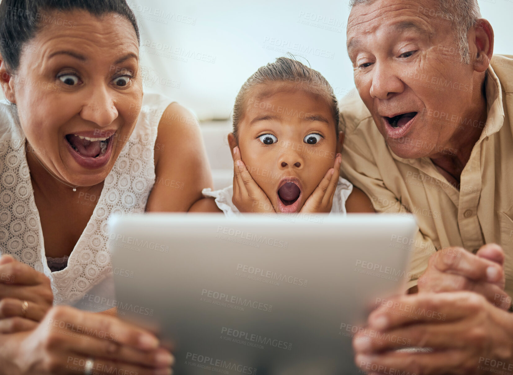 Buy stock photo Tablet, family and shocked face child look at video online bonding together at home. Wow grandparents, young girl and fun activity streaming movie or excited news on digital device in living room