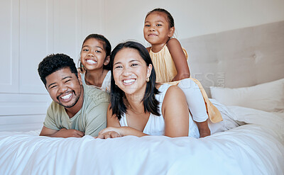 Buy stock photo Happy family with kids, smile and lying on bed in home, portrait of mother, father and children together in Asia. Love, fun and family time for dad, mom and daughters in family bedroom in Indonesia.
