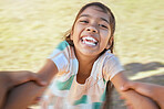 Face of happy girl swinging and spinning in circles by the arms at the park with his father. Cute playful kid having fun, laugh and smile while bonding with a parent on a sunny summer outdoor
