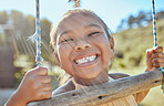 Smile, teeth and small girl on swing in outdoor park, happiness fun and playing outside in Indonesia. Health, happy face and a portrait of a young child swinging in garden at home in summer holiday.
