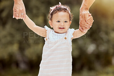 Buy stock photo Baby, walking and learning with holding hands with parents in garden, help and girl. Child, walk and teaching to balance, coordination or motor skills for steps with support, care or love in backyard