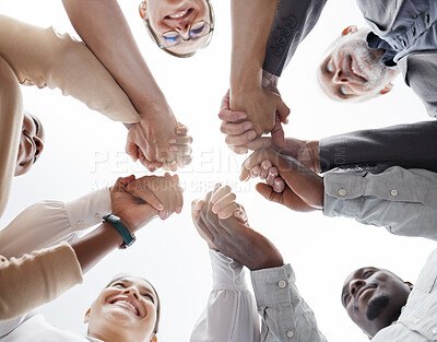 Buy stock photo Hands, teamwork and motivation with a business team in a huddle or circle together from below. Collaboration, success and community with a man and woman employee group standing hand in hand in unity