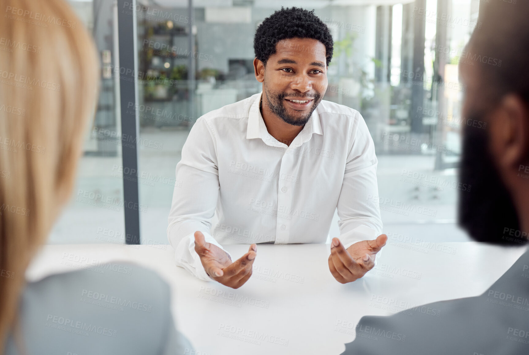 Buy stock photo Black businessman, meeting or job interview in office boardroom with human resources, recruitment or corporate hiring managers. Talking worker, employee or hr candidate with happy smile or motivation