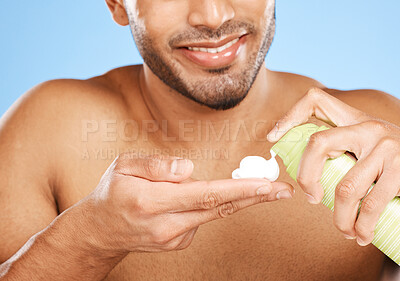 Buy stock photo Hand, shaving cream and man in studio for skincare, beauty and hair care against a blue background with mockup. Hands, foam and face hair grooming with model cleaning, hygiene and skin care product