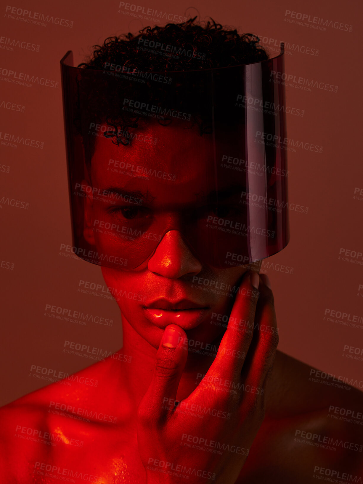 Buy stock photo Cyberpunk, glasses and man in red studio, lighting, model and fashion in the future. Dark, tech and face portrait of male with futuristic, edgy and modern style with visor for cyber punk aesthetic