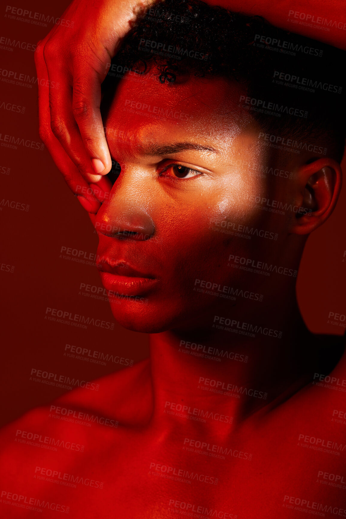 Buy stock photo Red beauty, light and face of model with creative shadow design, artistic neon lighting and luxury skincare. Sweat, hard work and aesthetic creativity of serious black man isolated on red background 