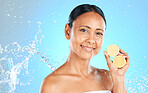 Lemon, skincare and beauty woman in studio mock up water splash for face, facial wellness and healthy glow portrait for advertising. Model with fruit for dermatology or vitamin c on blue mockup