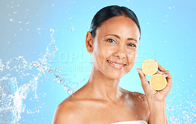 Buy stock photo Lemon, skincare and beauty woman in studio mock up water splash for face, facial wellness and healthy glow portrait for advertising. Model with fruit for dermatology or vitamin c on blue mockup