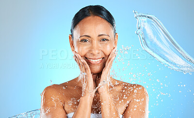 Buy stock photo Beauty, splash and water with portrait of woman for skincare, shower and wellness. Hydration, fresh and hygiene with mature face model for luxury, relax and spa against a blue background in studio 