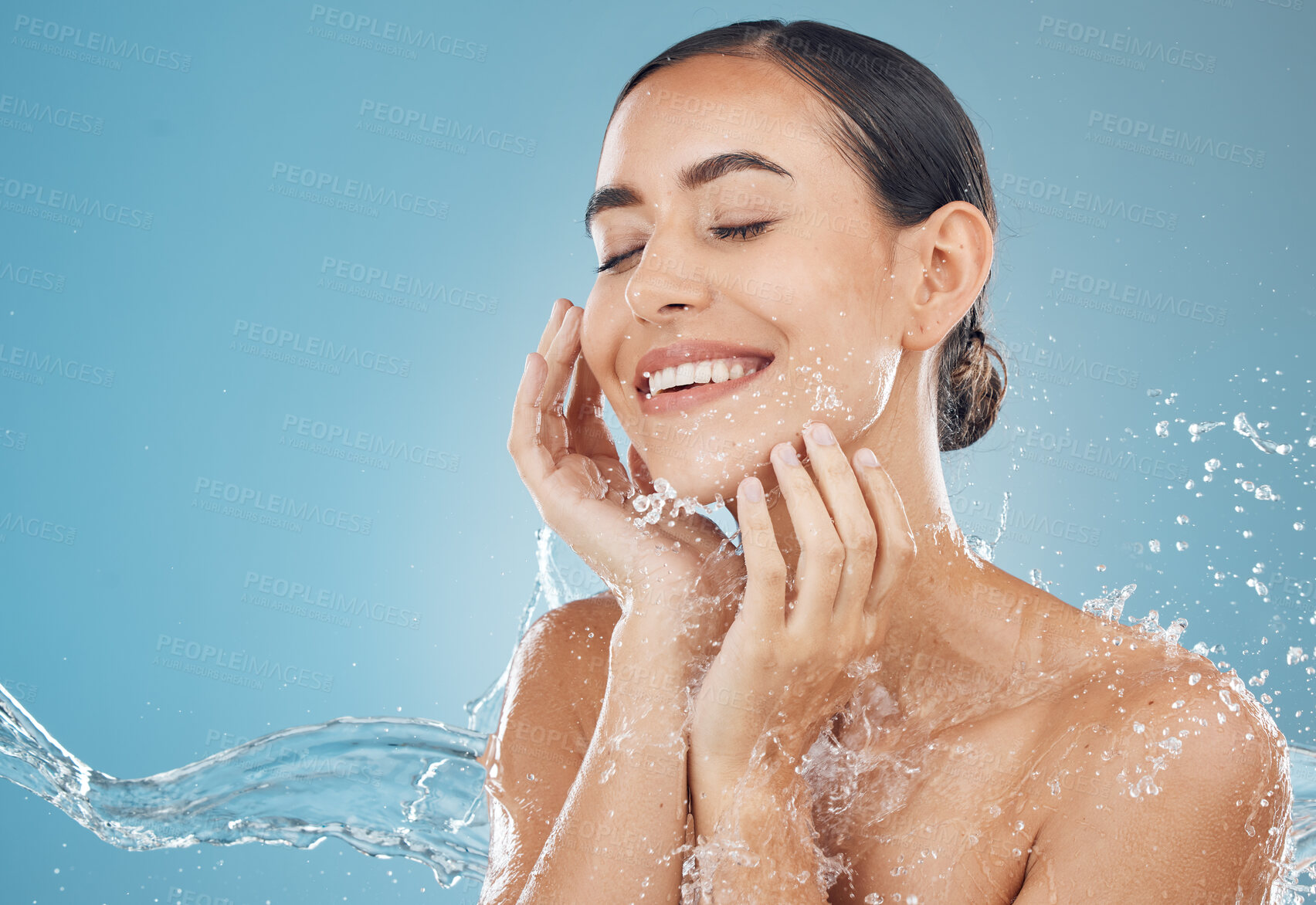 Buy stock photo Beauty, skincare and splash of water with woman for wellness, hydration and fresh spa. Relax, smile and health with girl against blue background with mock up for luxury, natural cosmetics and shower

