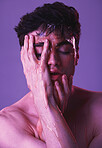 Face, honey and man in studio for skincare, beauty and organic products for facial. Natural beauty products, skincare products and young male model with dripping syrup on hands on purple background