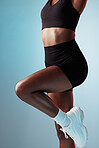 Stretching, body and abs of a woman training, doing fitness and exercise against a blue mockup studio background. Stomach, workout and wellness for an athlete doing a warm up for sport with legs