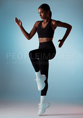 Buy stock photo Runner, fitness and woman with energy while training, running and doing exercise against a blue mockup studio background. Gym, workout and athlete girl with a jump while doing cardio for body
