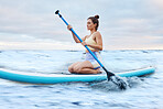 Woman, fitness and paddle board in sea for fitness, training and workout outdoor in nature with paddle. Sport athlete, healthy and exercise in ocean water for health, wellness and cardio practice 