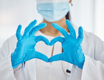 Doctor, hands and heart gesture for healthcare, love or trust for health and safety at the hospital. Hand of female nurse showing hearty emoji, icon or sign in medical protection at covid clinic